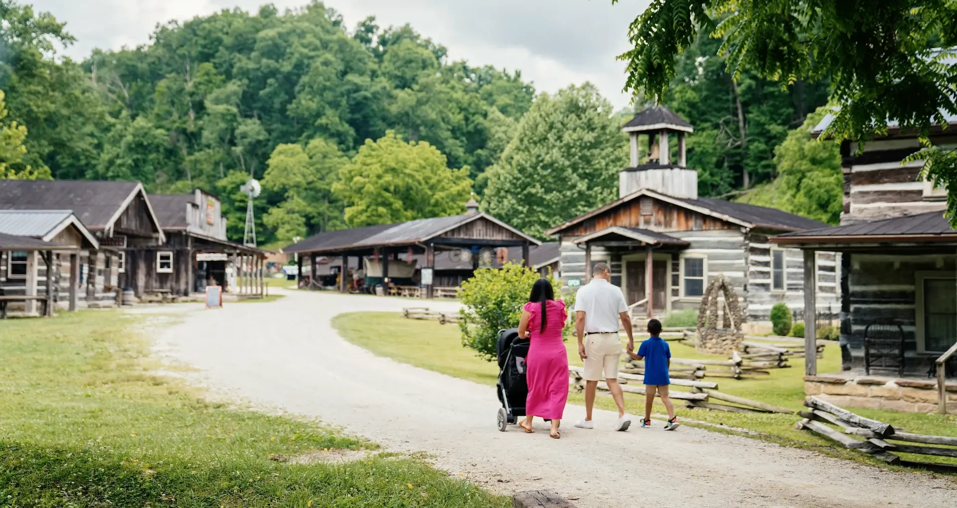 Family walking through Heritage Farm Museum & Village near Huntington, West Virginia — a hands-on historical attraction with pioneer cabins and interactive exhibits, perfect for family outings and cultural tourism